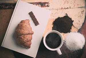 Croissant and coffee with book