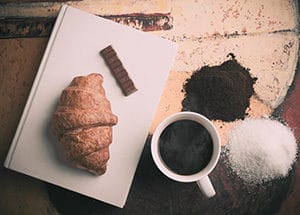Croissant and coffee with book