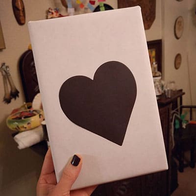 wrapped book with a black heart on the front for blind date with a book