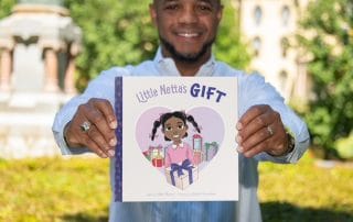 Author Mike Brown holding Little Netta's Gift
